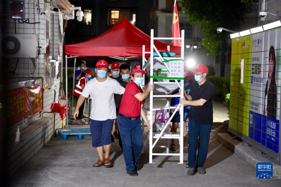 9月28日，厦门惠祥花园小区志愿者将管控期间存放快递的货架搬离。新华社记者 姜克红 摄
