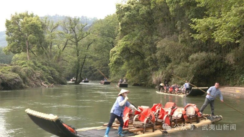 游客坐在竹筏上远眺群山、观赏水景，在流动的山水间感受春日出游的美好。