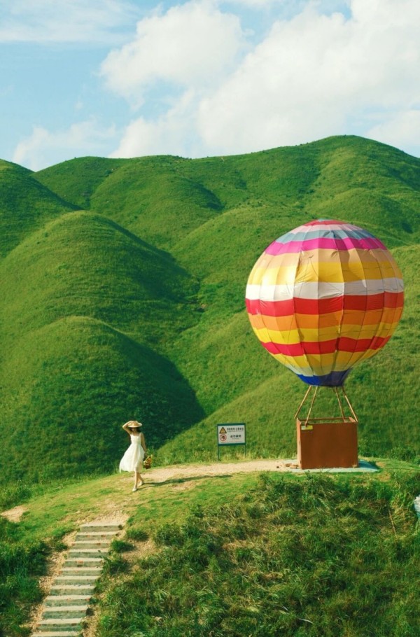 缆车缓缓上升，就能看见热气球、七彩栈道、风车等打卡元素散落在草场各处，让人仿佛徜徉于童话世界。郑雅丽 摄