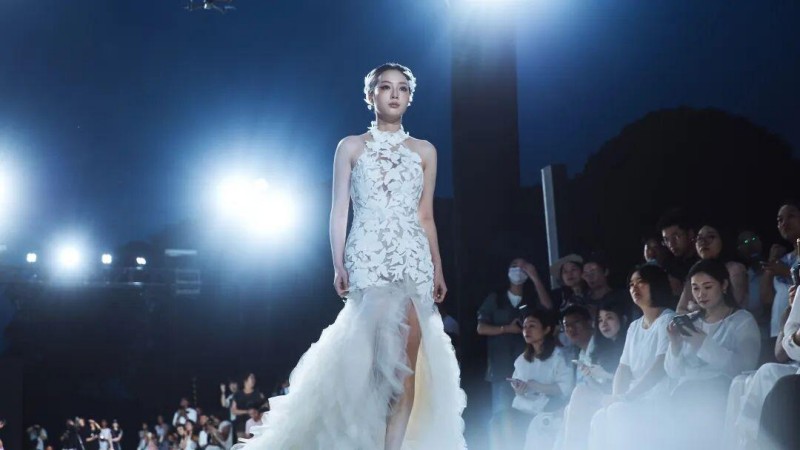 西式婚纱飘逸灵动、浪漫唯美，中式嫁衣剪裁考究、典雅端方，台下观众纷纷举起手机定格瞬间，沉浸式领略山水与嫁衣碰撞的独特美感。