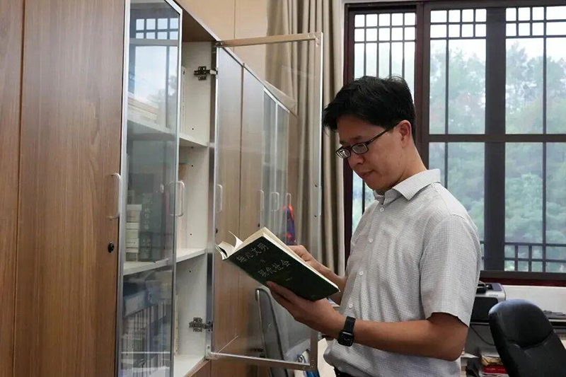 黄柏翰阅读工作相关书籍。（林李冰 摄）
