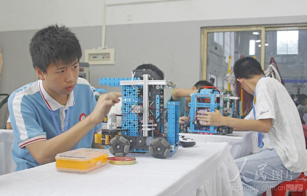 7月30日，在福建省泉州市泉港区益海实验小学荷盈馆机器人（篮球模拟）中学组候赛区，选手在检查、调校参赛机器人。