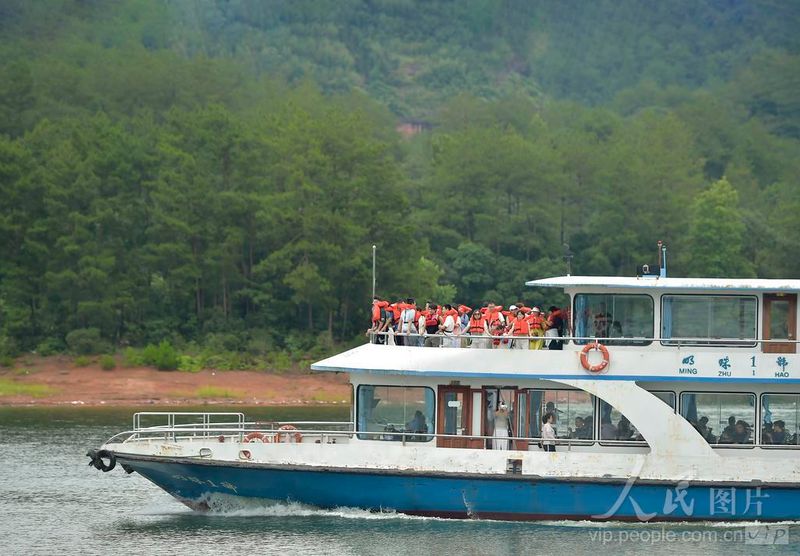 福建泰宁大金湖，观光游船行驶湖面，游客身着救生衣游览欣赏水上丹霞风光。