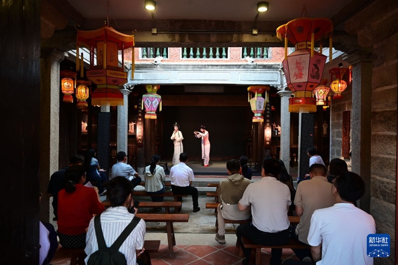 8月18日，游客在泉州市洛江区桥南古街的陈三五娘沉浸体验剧场，观看福建省梨园戏传承中心演员表演《陈三五娘》。新华社记者 林善传 摄