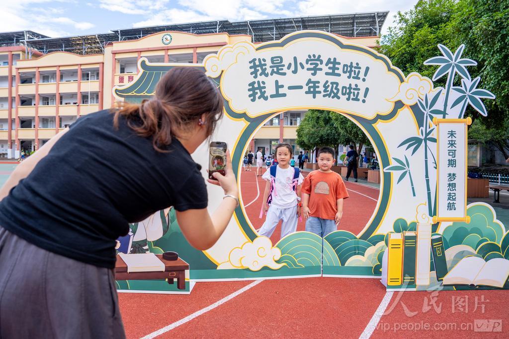 9月1日，福建省南平市松溪县河东中心小学，家长在打卡拍照区给孩子们拍照留念。