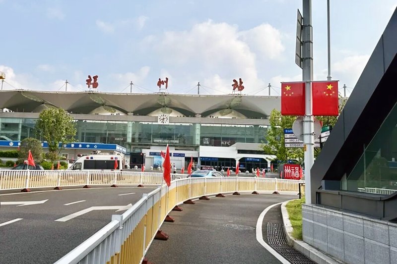 福州火车站内外被浓浓的“中国红”包裹，鲜艳的红旗在风中猎猎作响，悬挂的国旗好似迎风展翅的红绸，中国结等红色吊饰如流苏轻轻垂落，温暖着步履匆匆的旅客。