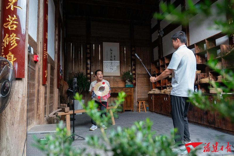 9月30日，钟椿源（右1）与村民一起拍摄国庆晚会的宣传片。