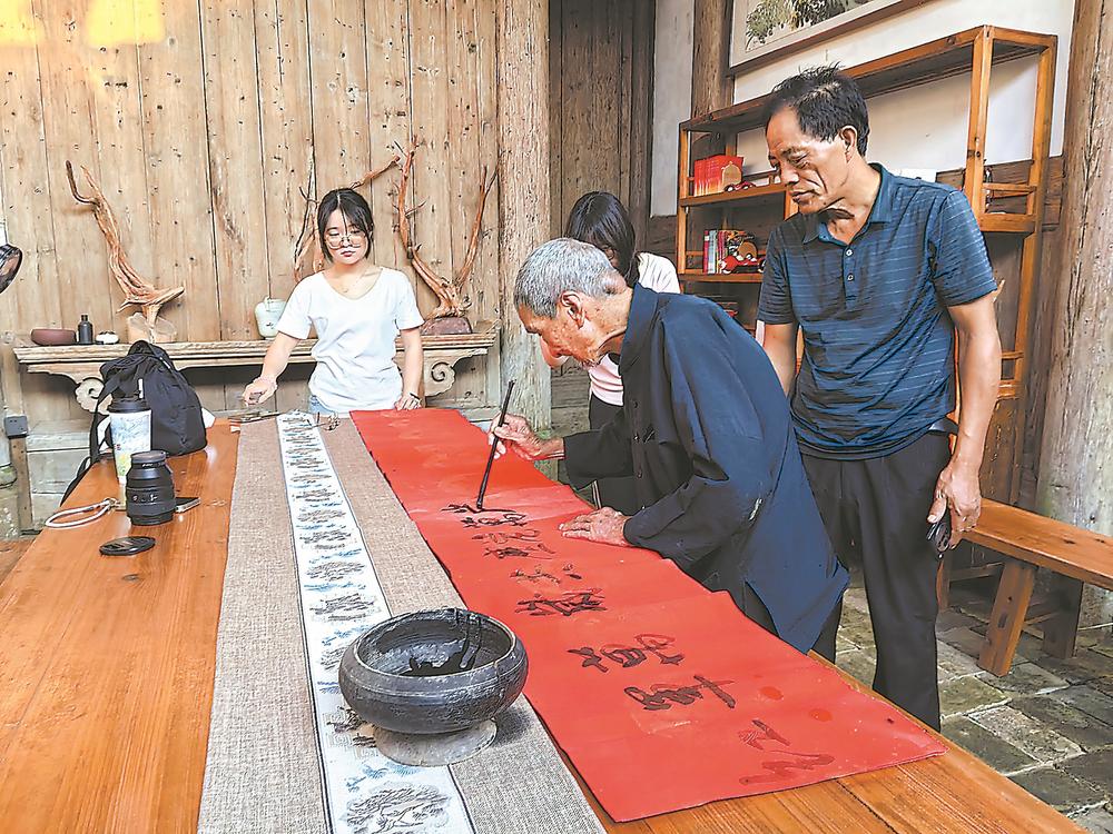 曹登鑫老人倾情书写：红军万岁，共产党万岁。 黄筱菁 摄
